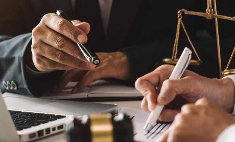 business people and lawyers discussing contract papers sitting a